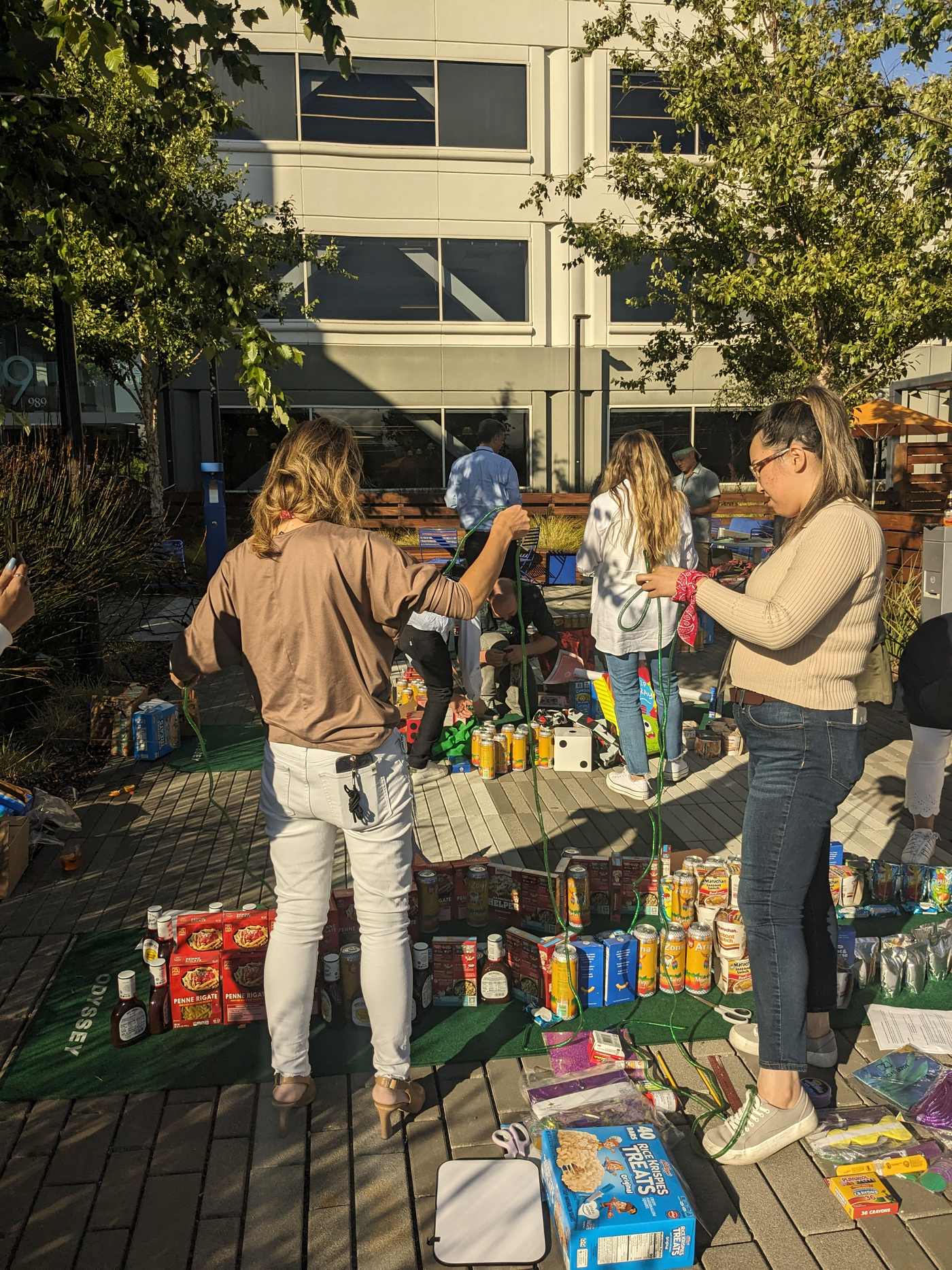 A group works together beside rows of canned food